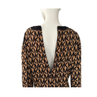 Mannequin wearing a patterned jumper with 'MK' logo on a white background