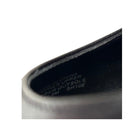 Close-up of a shoe sole with text on a white background
