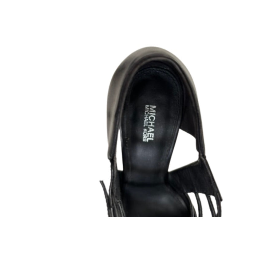 Black sandal with fringe details on a white background