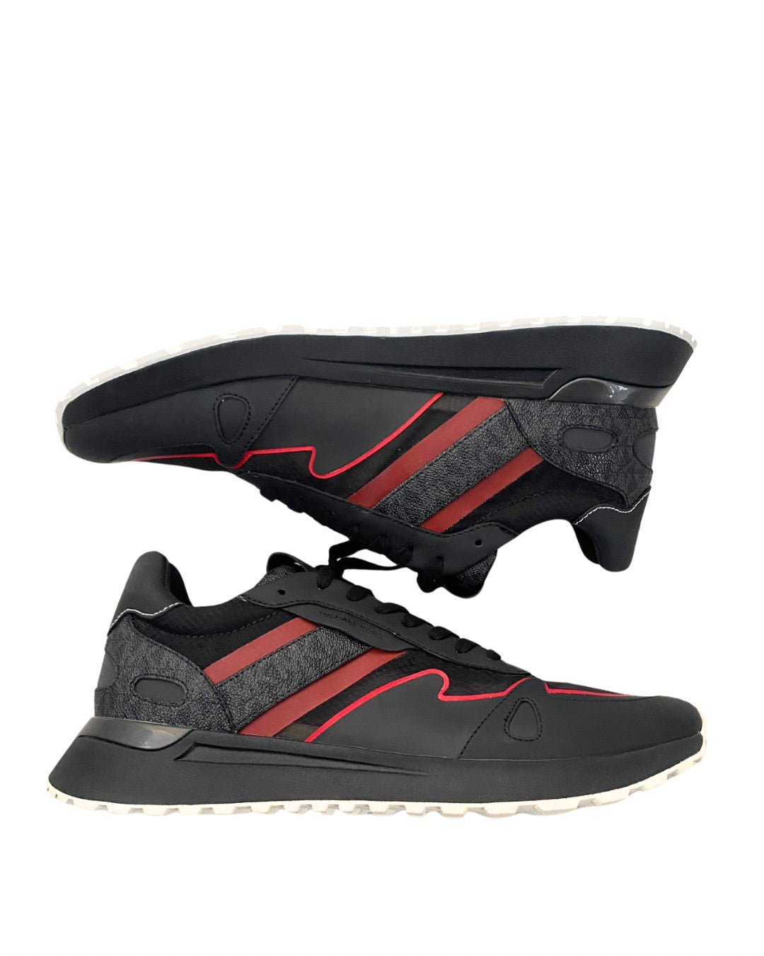 Black and red athletic shoes with a white sole on a white background