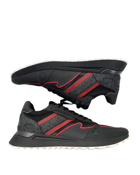 Black and red athletic shoes with a white sole on a white background