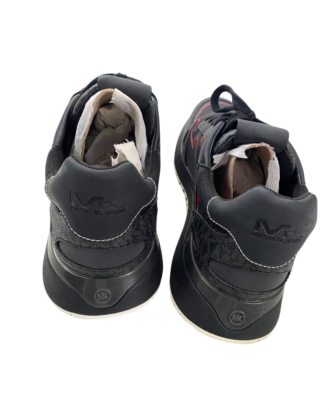 Pair of black sneakers with visible brand logo on a white background