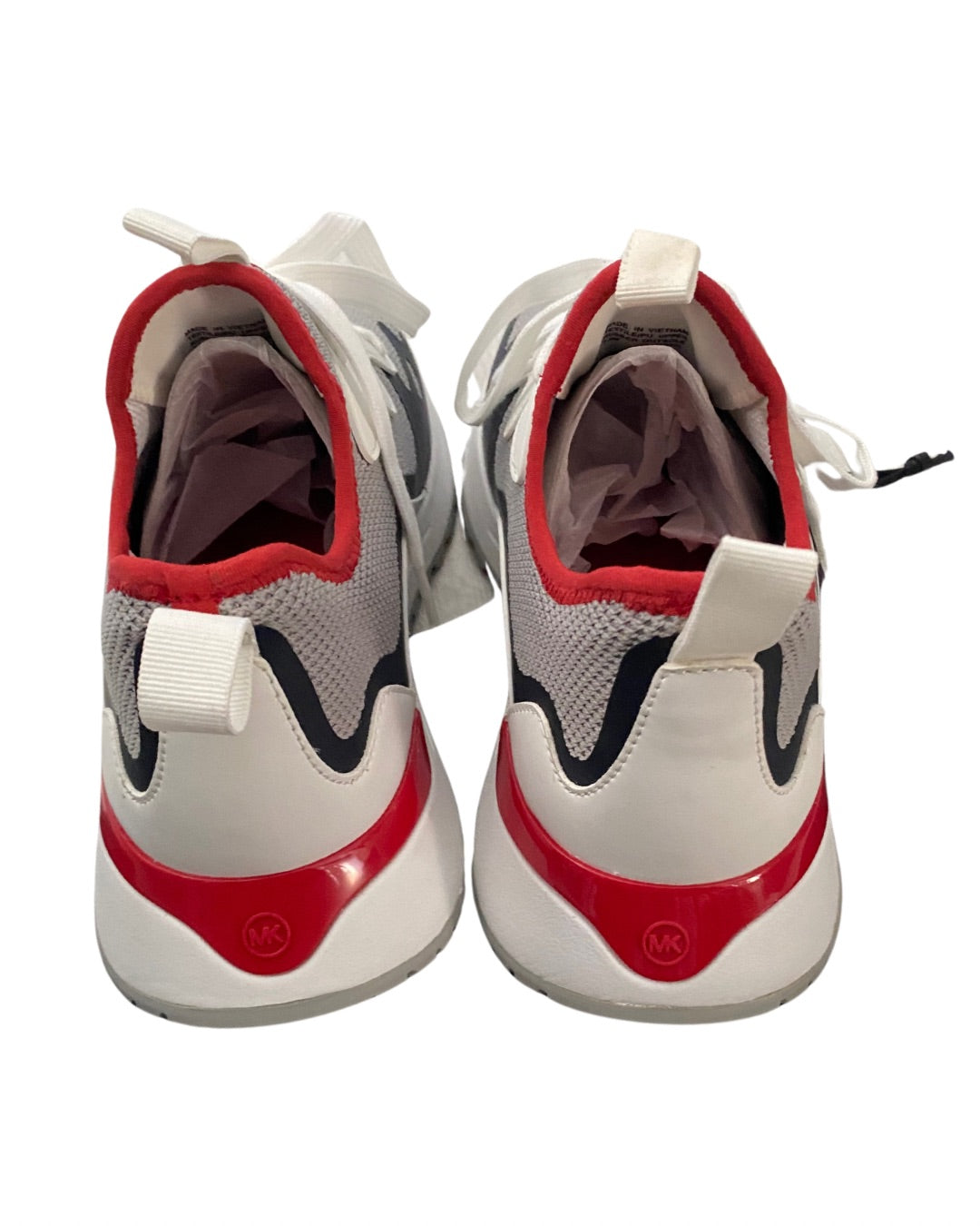 Pair of red, white, and gray sneakers on a white background