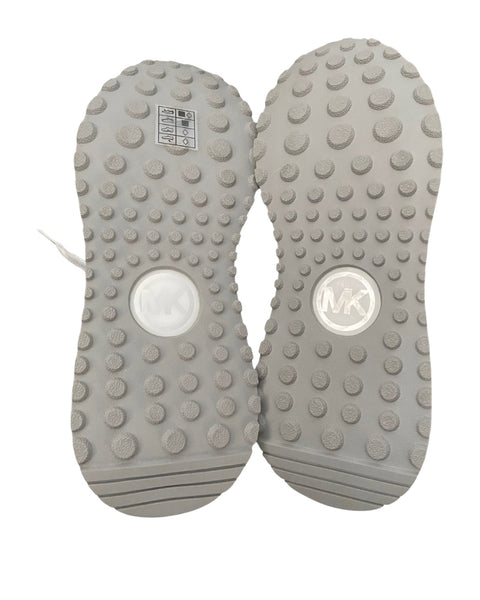Gray shoe soles with textured surface and brand logo on a white background