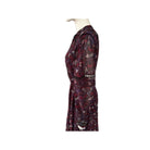 Mannequin wearing a burgundy dress with paisley pattern on a white background
