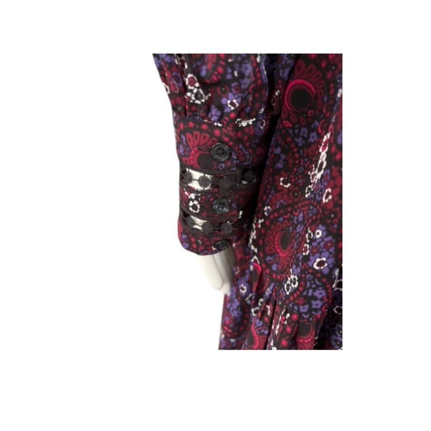 Close-up of a paisly dress cuff with a white background