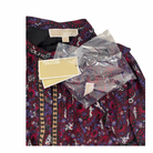 Patterned dress with tags and packaging on a white background