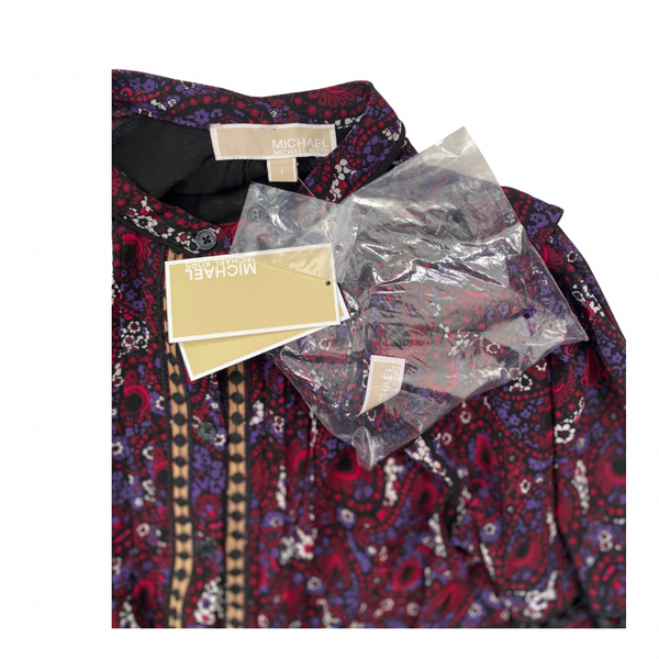 Patterned dress with tags and packaging on a white background