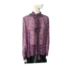 Floral blouse on a mannequin against a white background