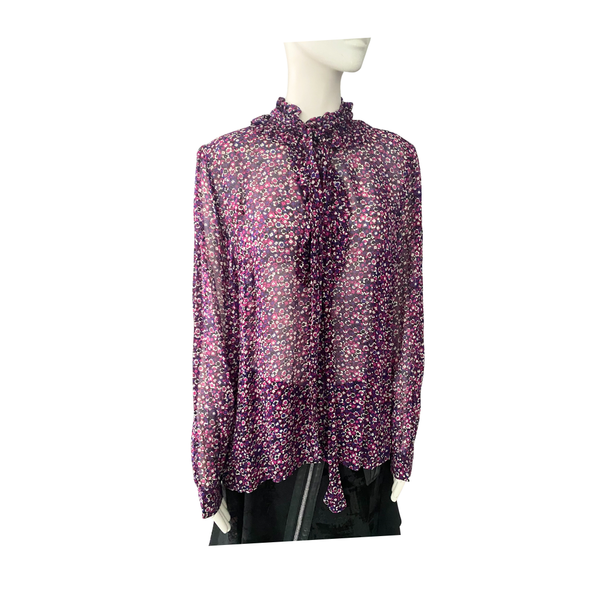 Floral blouse on a mannequin against a white background