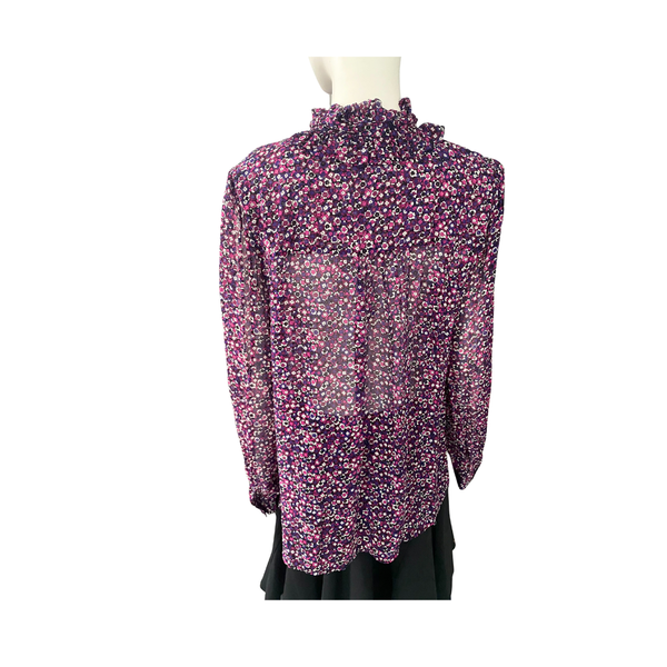Floral patterned blouse on a mannequin against a white background