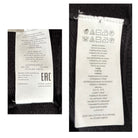 Two clothing labels with text and symbols on a black background