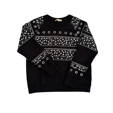 Black sweater with white pattern and grommets on a white background