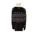 Black sweater with white bead patterns on a mannequin against a white background