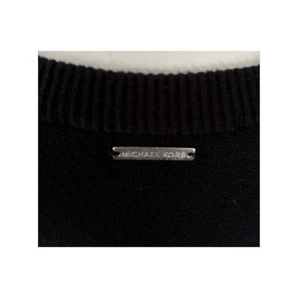 Black knit sweater with a visible brand label on a white background