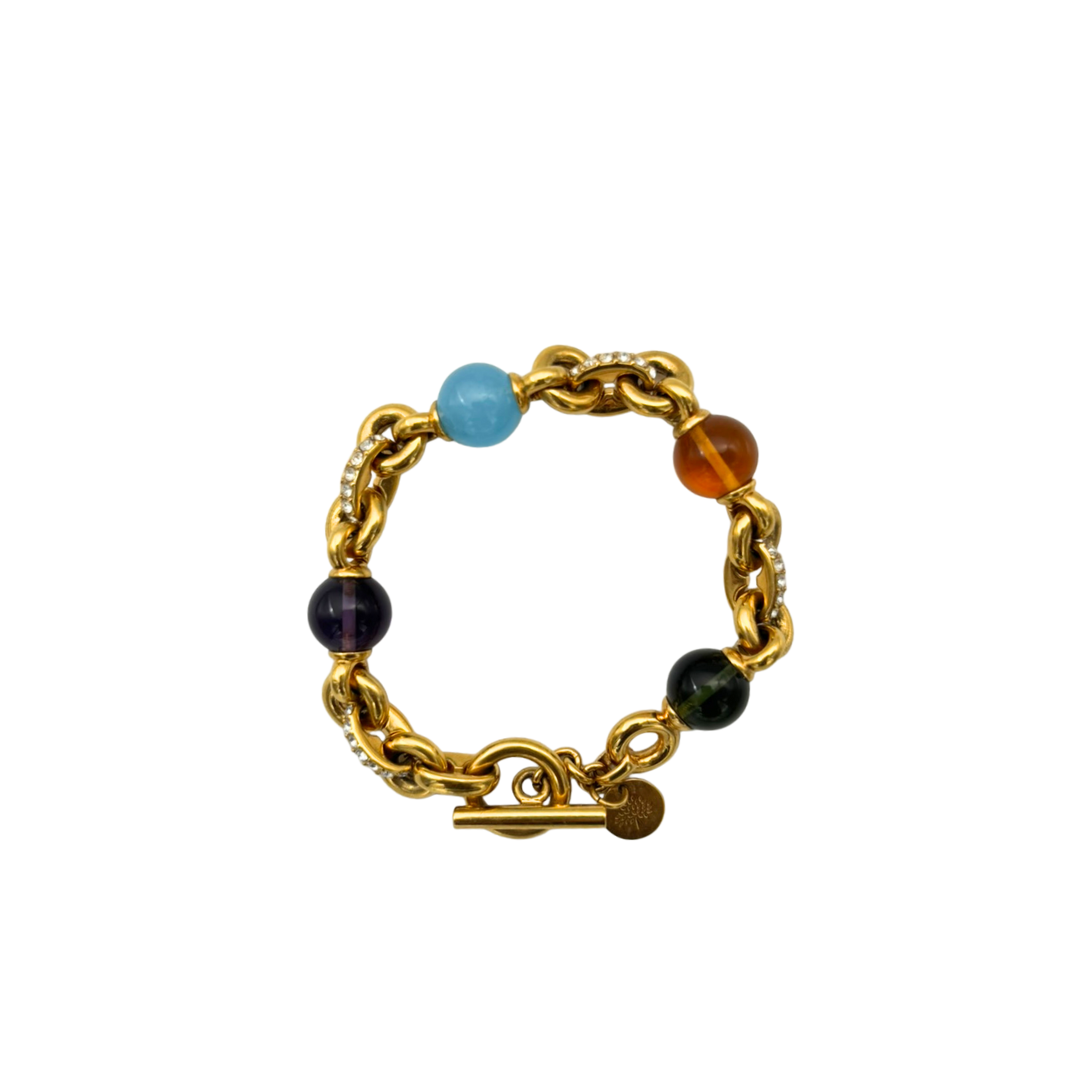 Gold chain bracelet with colorful beads on a white background