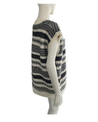 Mannequin wearing a black and white patterned sweater on a white background