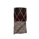 Folded argyle patterned fabric on a white background