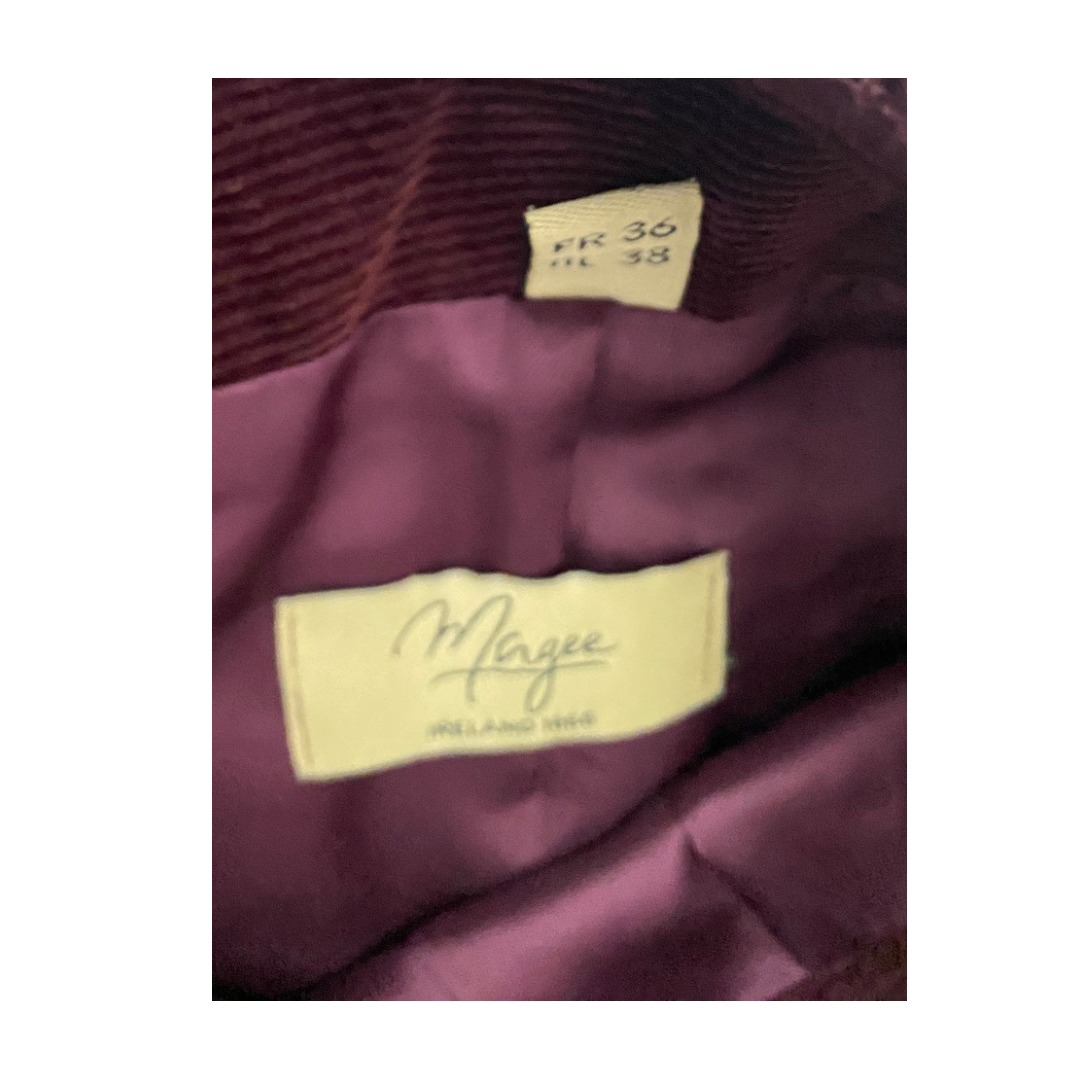 Close-up of a burgundy fabric with a label and size tag.