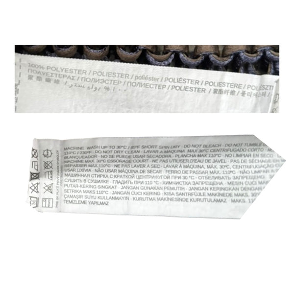 Close-up of fabric label with text and symbols on a white background