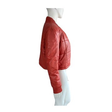 Orange puffer jacket on a mannequin against a white background