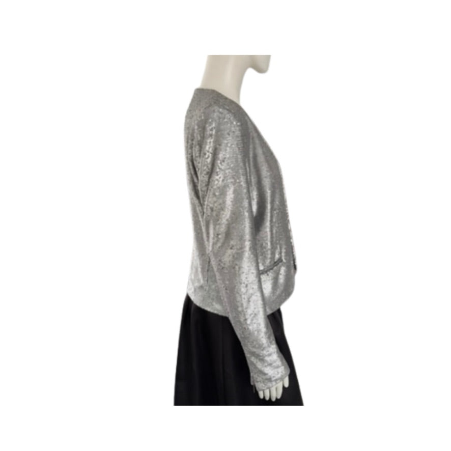 Mannequin wearing a silver sequin jacket and black skirt on a white background