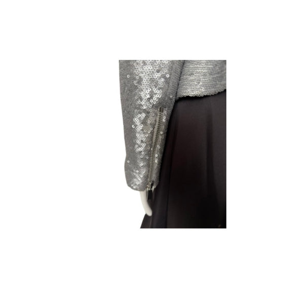 Silver sequined jacket with a black skirt on a white background