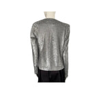 Silver sequin top on a mannequin against a white background
