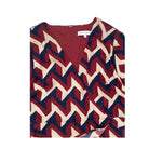 Burgundy, cream and navy zigzag patterned top on a white background