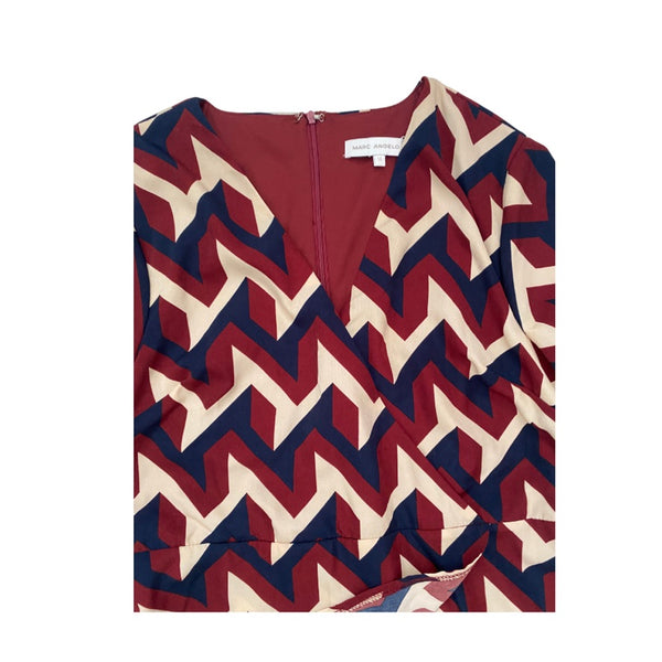 Burgundy, cream and navy zigzag patterned top on a white background