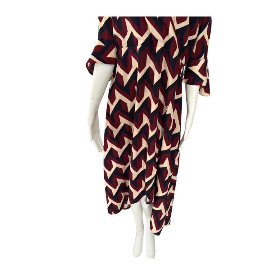 Mannequin wearing a dress with a zigzag pattern on a white background