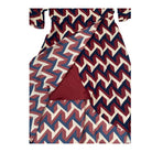Burgundy, cream, and blue zigzag patterned dress on a white background