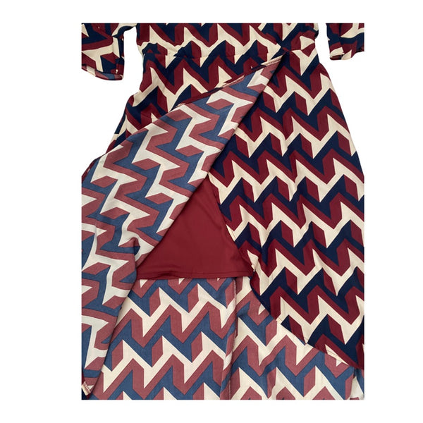 Burgundy, cream, and blue zigzag patterned dress on a white background