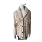 Beige cable knit cardigan on a mannequin against a white background