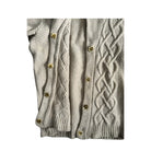 Beige cable knit cardigan with gold buttons on a white background