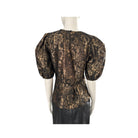 Black brocade top on a mannequin against a white background