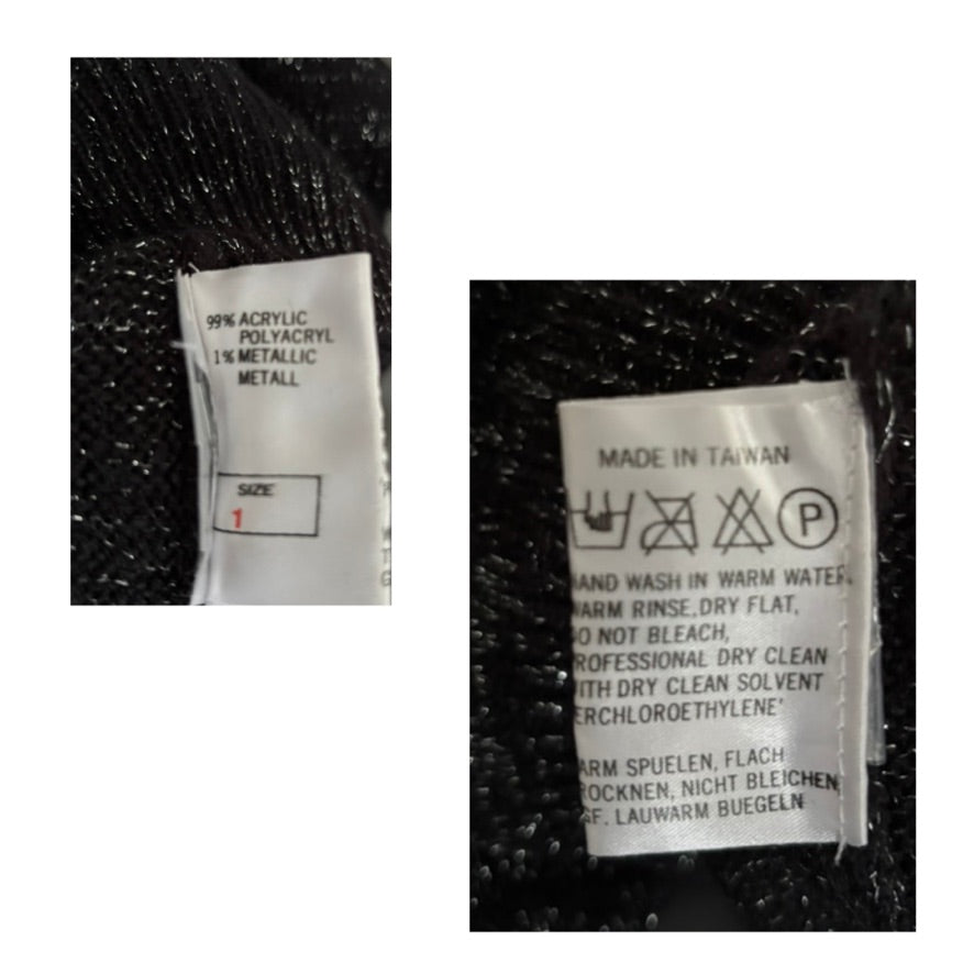 Close-up of fabric labels with text and symbols on a textured black background