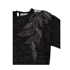 Grey sweater with white leaf pattern on a white background