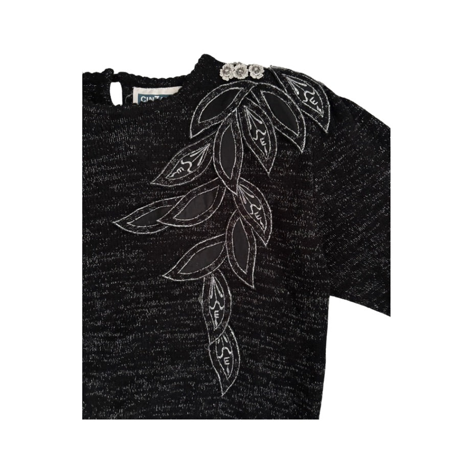 Grey sweater with white leaf pattern on a white background