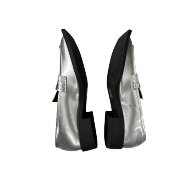 Pair of silver high-heeled shoes with black soles on a white background