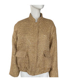Gold knit cardigan on a mannequin against a white background