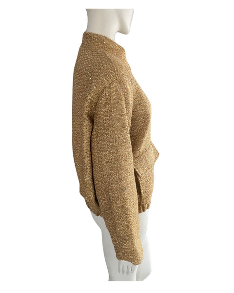 Gold textured sweater on a mannequin against a white background