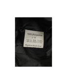 Clothing label on black fabric with washing instructions