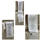 Collage of multiple clothing labels on a textured fabric background