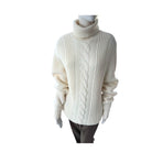 White cable knit sweater on a mannequin against a white background