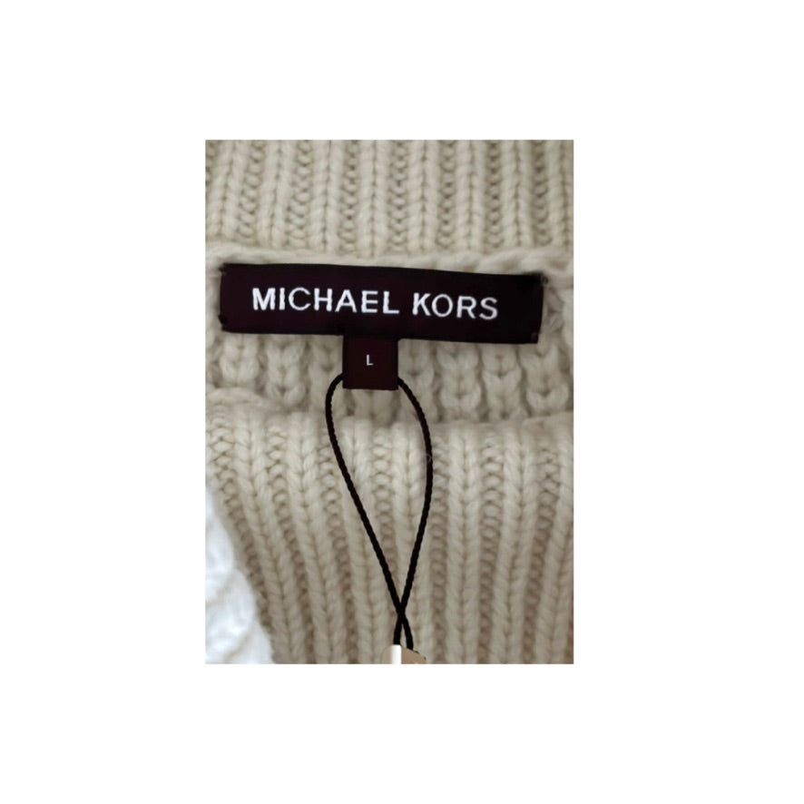 Close-up of a Michael Kors label on a beige knitted sweater.
