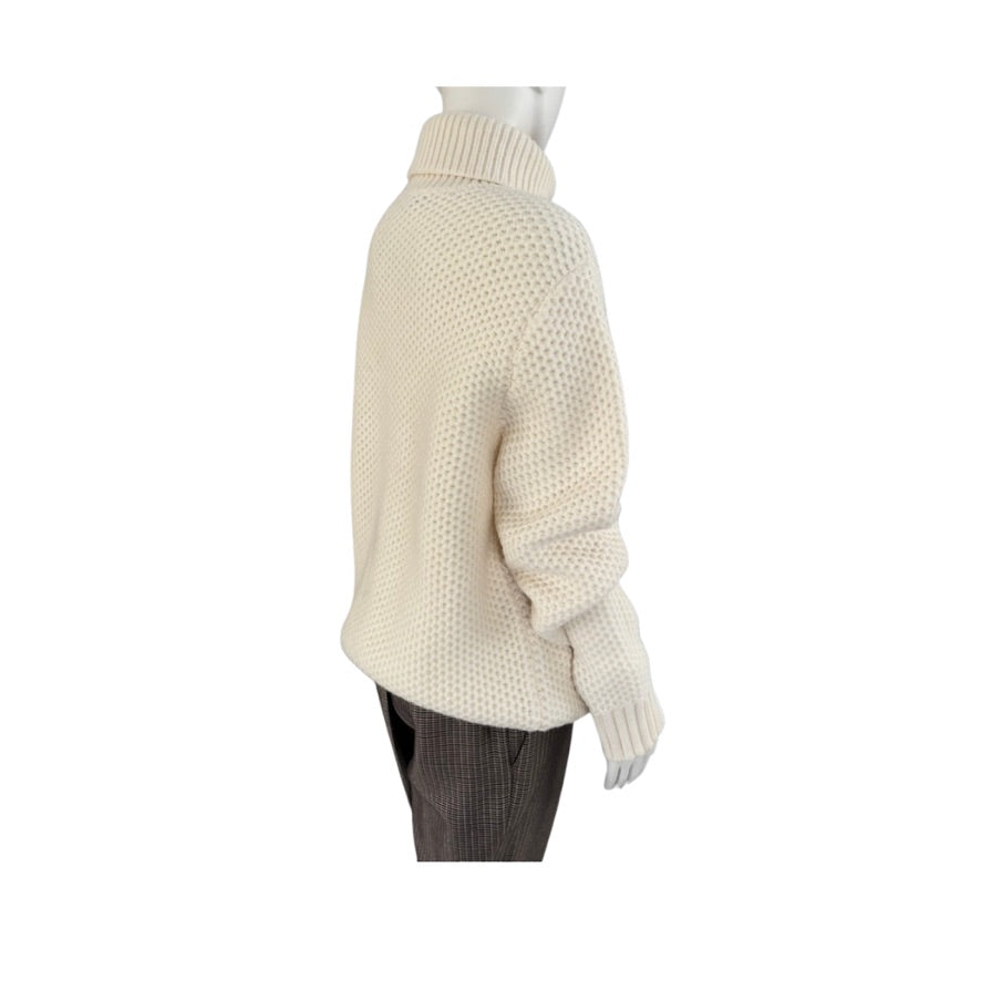 Mannequin wearing a cream knitted sweater on a white background