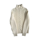 White turtleneck sweater with cable knit pattern on a white background