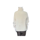 White knit sweater on a mannequin against a white background