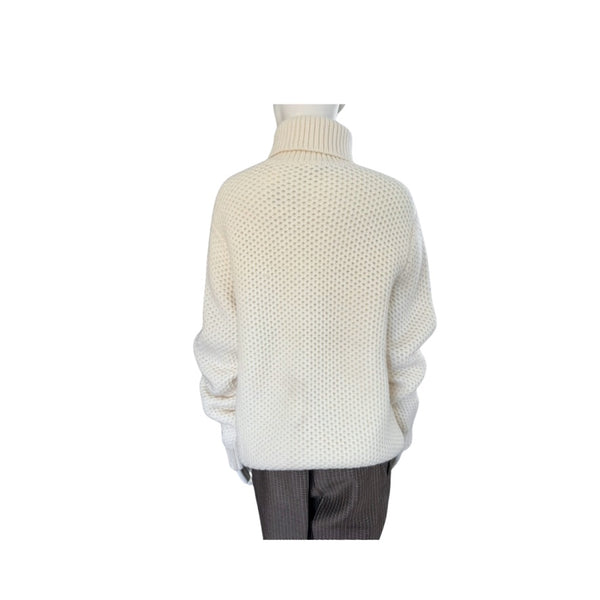 White knit sweater on a mannequin against a white background